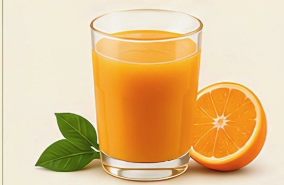 A glass of fresh orange juice beside a halved orange